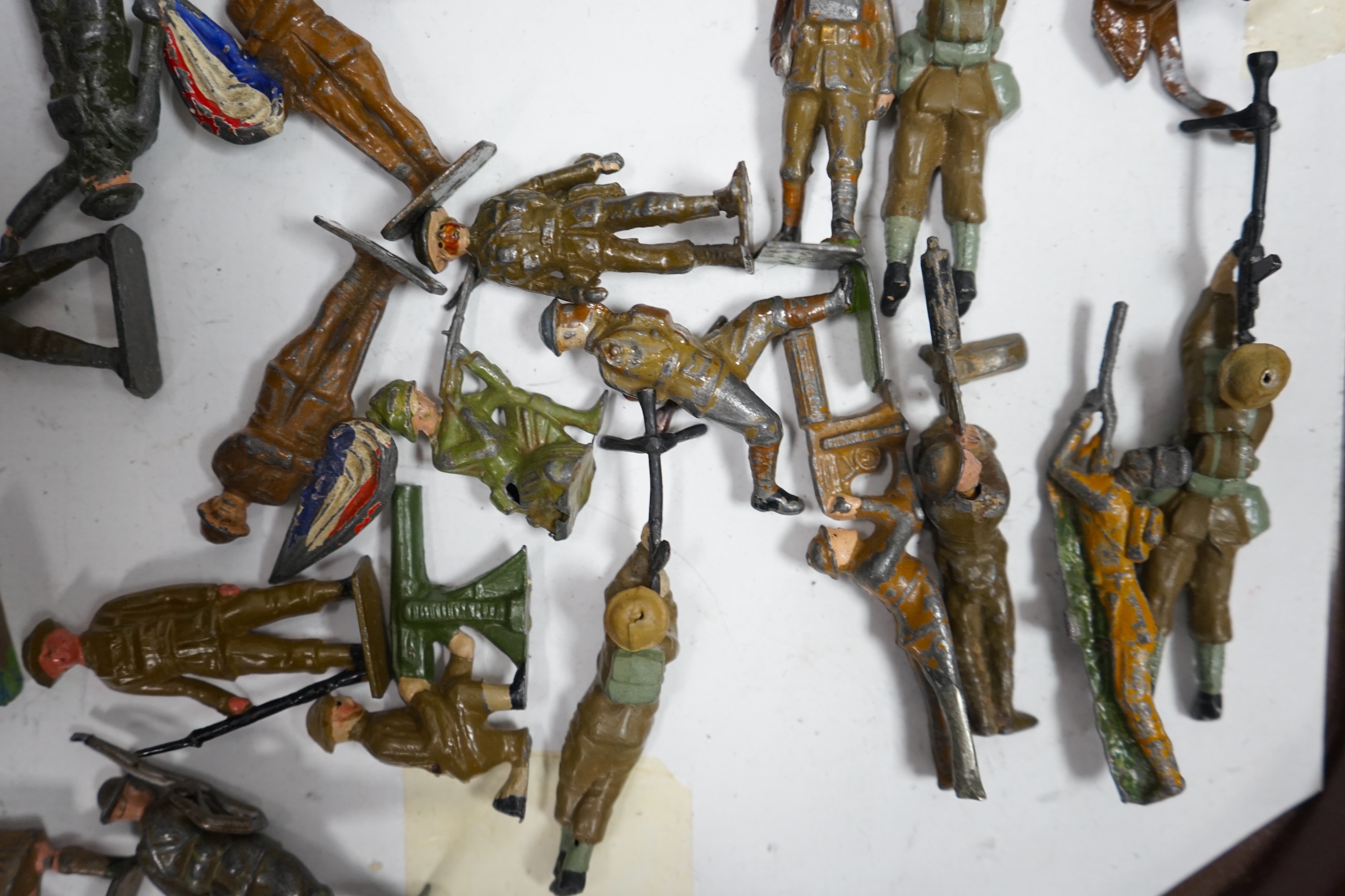 A collection of Britains lead soldiers, mostly British infantry in khaki, including some with gas masks, together with railway station figures by Johillco, etc., plus two Coronation tins, etc. Condition - poor to fair.